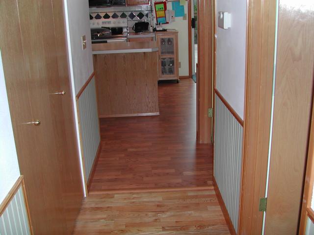 From the entry hall, transition from old wood floor